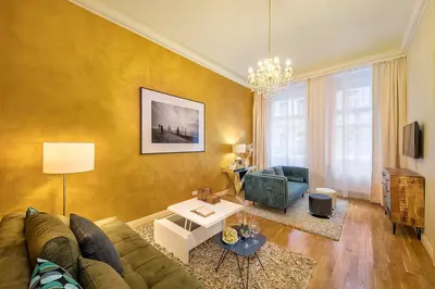 a living room with a couch and a table at Prague Days - Luxurious Apartments Lesser Town in Prague