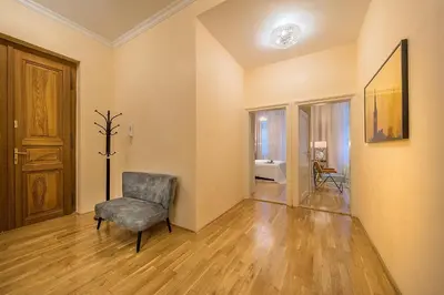 an empty room with a chair and a door at Prague Days - Luxurious Apartments Lesser Town in Prague