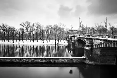 a black and white photo of a bridge over a river at Prague Days - Luxurious Apartments Lesser Town in Prague