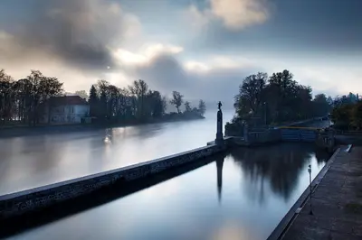 a river with a lighthouse in the middle of it at Prague Days - Luxurious Apartments Lesser Town in Prague