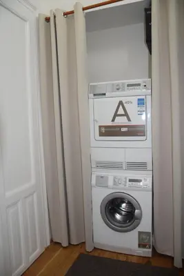 a washing machine in a room next to a door at Palackeho Apartment in Prague