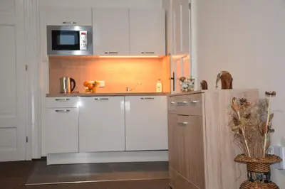 a kitchen with white cabinets and a microwave at Palackeho Apartment in Prague