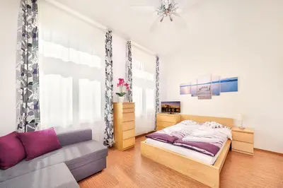 a bedroom with a bed and a couch at Paradise Apartment in Prague