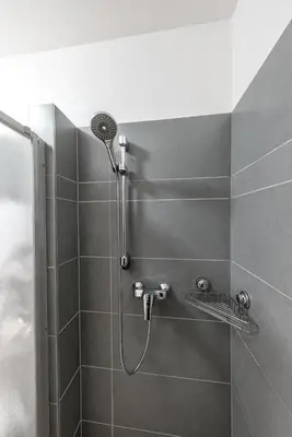 a shower with a shower head in a bathroom at Paradise Apartment in Prague