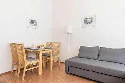 a living room with a couch and a table with chairs at Paradise Apartment in Prague