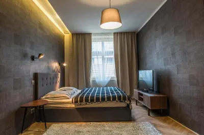 a bedroom with a bed and a tv and a window at Exclusive 3 Bedroom Top-Notch Flat, GREAT LOCATION in Prague