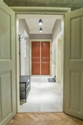 an empty hallway with a door and a bench at Exclusive 3 Bedroom Top-Notch Flat, GREAT LOCATION in Prague