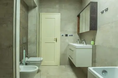a bathroom with a white toilet and a sink at Exclusive 3 Bedroom Top-Notch Flat, GREAT LOCATION in Prague