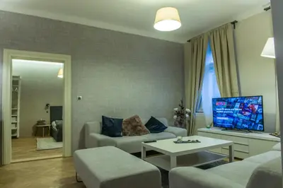 a living room with a couch and a tv at Exclusive 3 Bedroom Top-Notch Flat, GREAT LOCATION in Prague