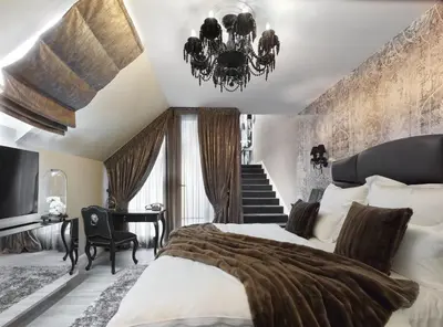 a bedroom with a large bed and a chandelier at PALOMA Průhonice in Pruhonice