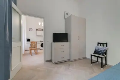 a living room with a tv and a dresser with a dresser at Vita Nejedleho apartments in Prague
