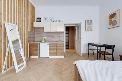 a kitchen with a refrigerator and a table in a room at Vita Nejedleho apartments in Prague