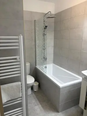 a bathroom with a bath tub and a toilet at Vita Nejedleho apartments in Prague