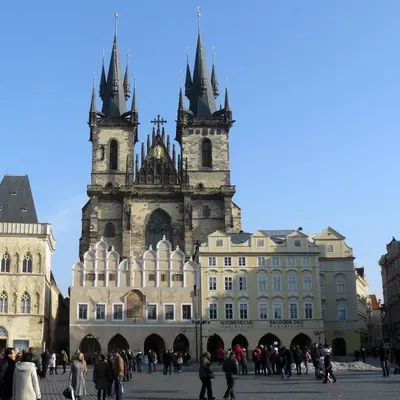 a large building with two towers with people walking around it at Nice and refreshing flat in Prague in Prague