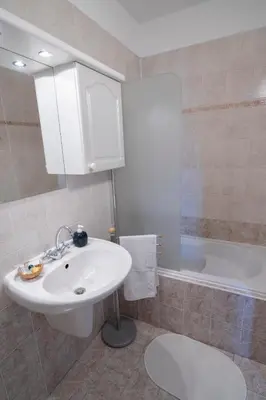 a bathroom with a sink and a bath tub at Penzion BEAKO na 