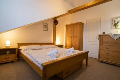 a bedroom with a bed and a dresser at Penzion BEAKO na 