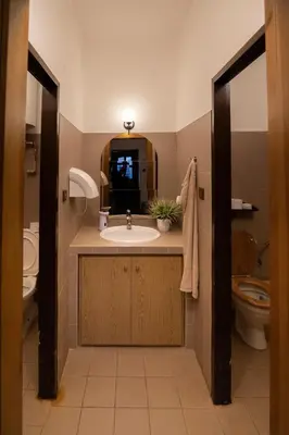 a bathroom with a sink and a toilet and a mirror at Penzion BEAKO na 