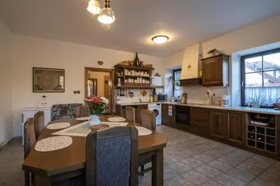 a kitchen with a table and a dining room at Penzion BEAKO na 