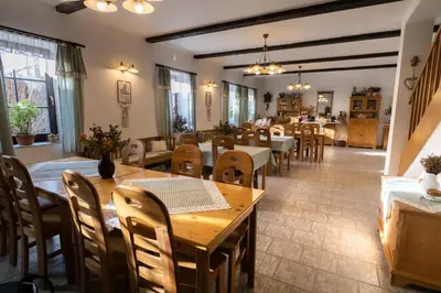 a dining room with wooden tables and chairs at Penzion BEAKO na 