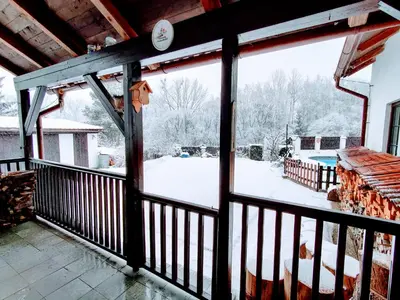 a screened porch with a view of a snow covered yard at Penzion BEAKO na 