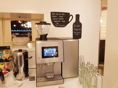 a kitchen counter with a blender and wine bottles at Pure White in Prague
