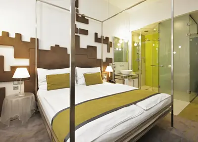 a bedroom with a large bed and a shower at Pure White in Prague