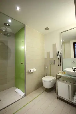 a bathroom with a shower and a toilet and a sink at Pure White in Prague