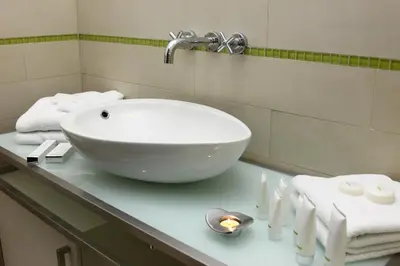 a bathroom with a sink and towels on a counter at Pure White in Prague