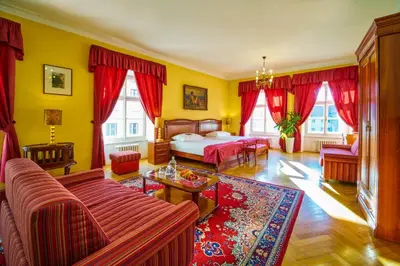a living room with a bed and a couch at Josephine Old Town Square Hotel - Czech Leading Hotels in Prague