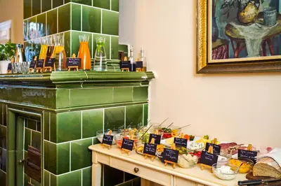 a table with many different types of food on it at Josephine Old Town Square Hotel - Czech Leading Hotels in Prague