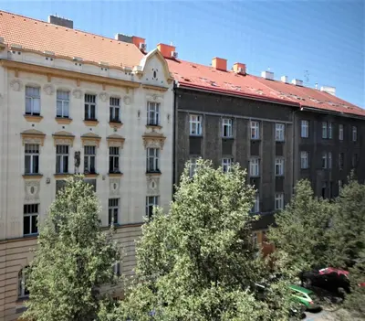 a large building with trees in front of it at City Castle Aparthotel in Prague