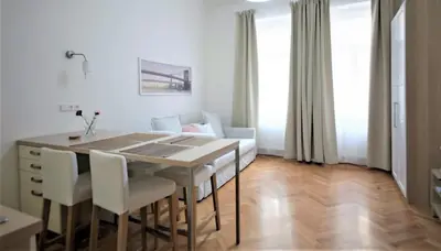 a kitchen and dining room with a table and chairs at City Castle Aparthotel in Prague