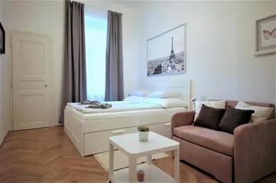 a living room with a bed and a couch at City Castle Aparthotel in Prague