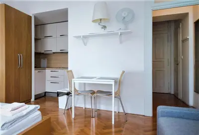 a small kitchen with a white table and chairs at City Castle Aparthotel in Prague