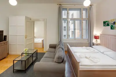 a living room with a bed and a couch at Charles Bridge Premium Residence in Prague