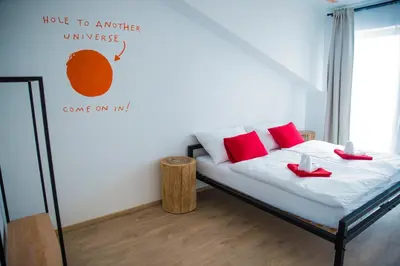 a bedroom with a bed with red shoes on it at Gregory House in Prague