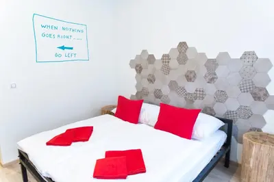 a bedroom with a white bed with red pillows at Gregory House in Prague