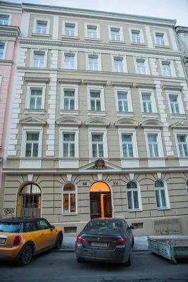 two cars parked in front of a large building at Gregory House in Prague