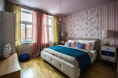 a bedroom with a large bed with a blue blanket at Stylish Apartments close to Eden Garden in Prague
