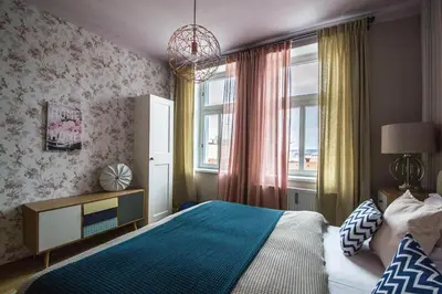 a bedroom with a bed and a large window at Stylish Apartments close to Eden Garden in Prague