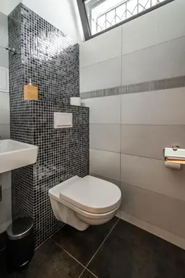 a bathroom with a toilet and a sink at Stylish Apartments close to Eden Garden in Prague