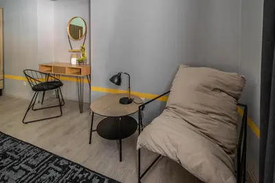 a bedroom with a bed and a table and a mirror at Stylish Apartments close to Eden Garden in Prague