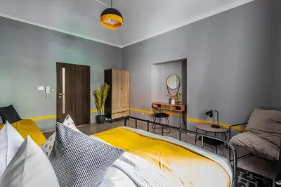 a living room with a bed and a couch at Stylish Apartments close to Eden Garden in Prague