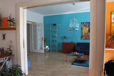 a living room with blue walls and a blue couch at Cosy Apartment Under the Tower in Prague