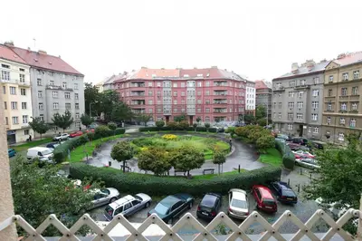 a parking lot with cars parked in a city at Cosy Apartment Under the Tower in Prague