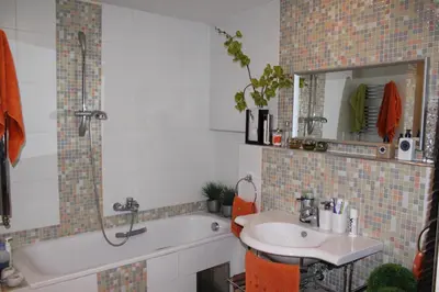 a bathroom with a sink and a bath tub at Cosy Apartment Under the Tower in Prague