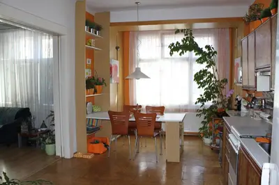a kitchen with a table and chairs in a room at Cosy Apartment Under the Tower in Prague