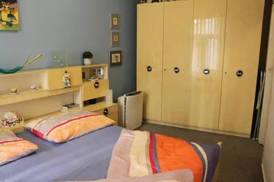 a bedroom with a bed and some cupboards at Cosy Apartment Under the Tower in Prague