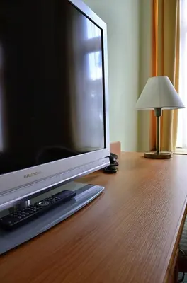 a computer monitor sitting on top of a wooden desk at Castle Residence Praha in Prague