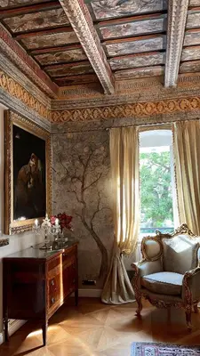 a room with a table and a chair and a window at Alchymist Prague Castle Suites Hotel in Prague